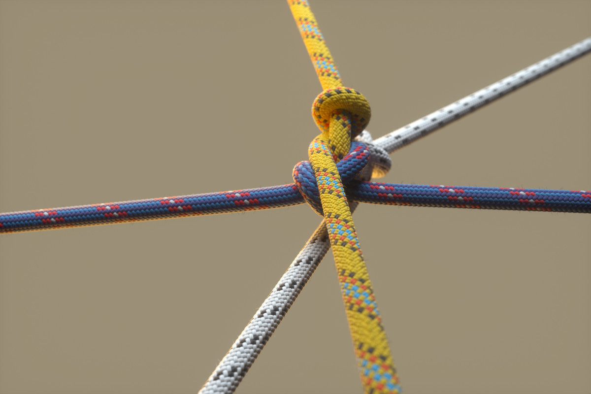 Ein Knoten an dem von verschiedenen Strängen gezogen wird