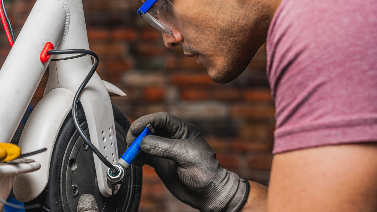 Mechaniker repariert E-Roller