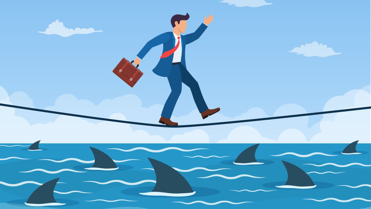 Geschäftsmann balanciert auf einem Drahtseil über Haie